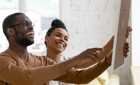 man and woman admiring new cabinet selection in home renovation project