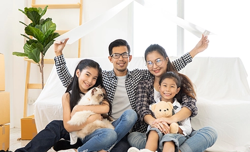 family of 4 holding up a roof as they move into new home
