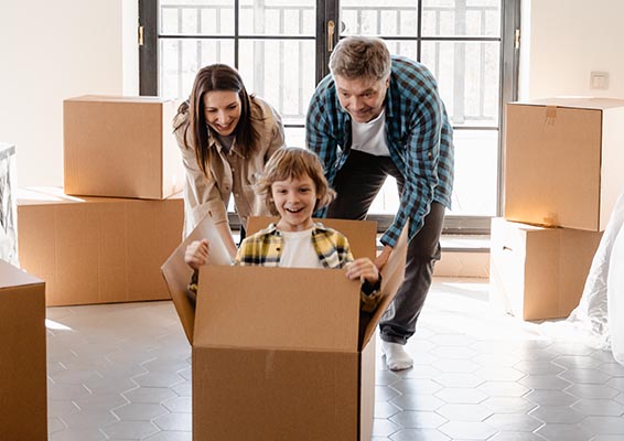 parents pushing kid in moving box