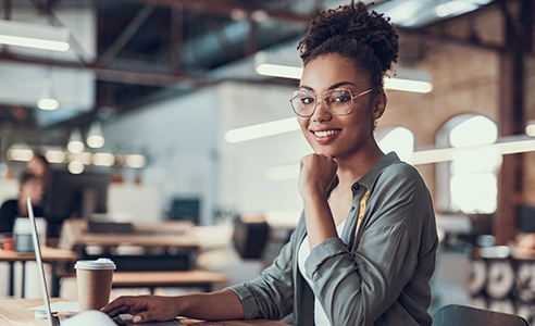 Woman working on laptop at modern office